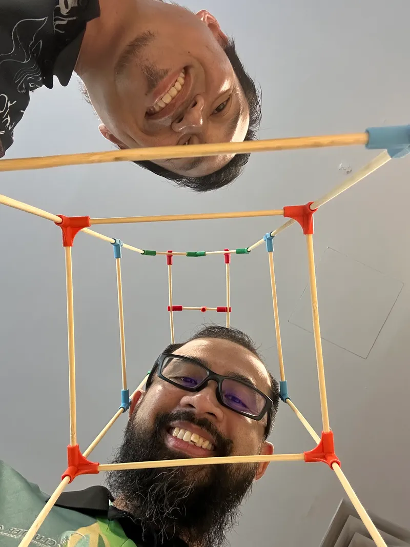 A teacher’s upside-down selfie through a chopstick cube