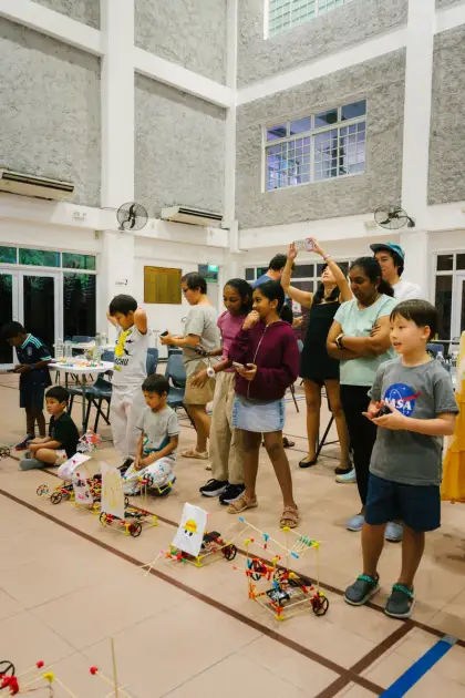 A tall hall full of robots and builders
