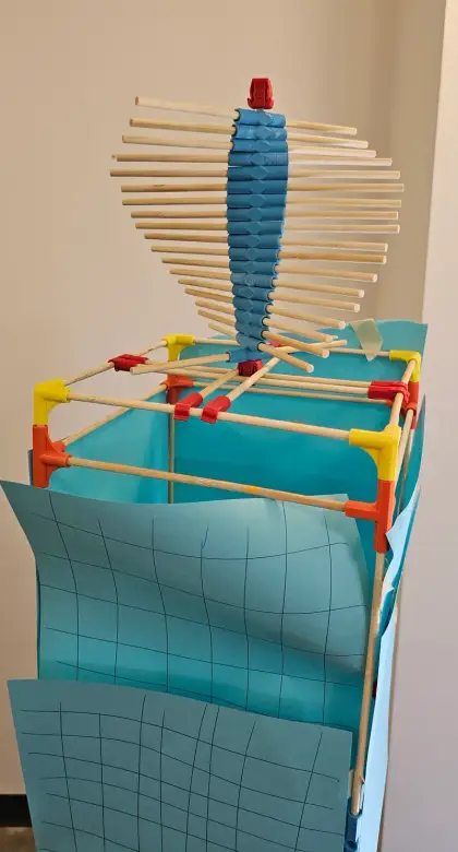 A tall spiral creation against the blue wall