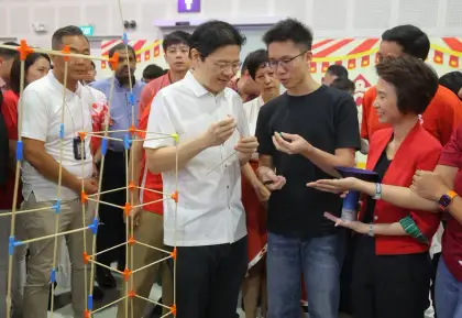 PM Lawrence Wong tries the connectors