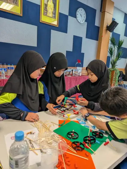 Girls building at a round table