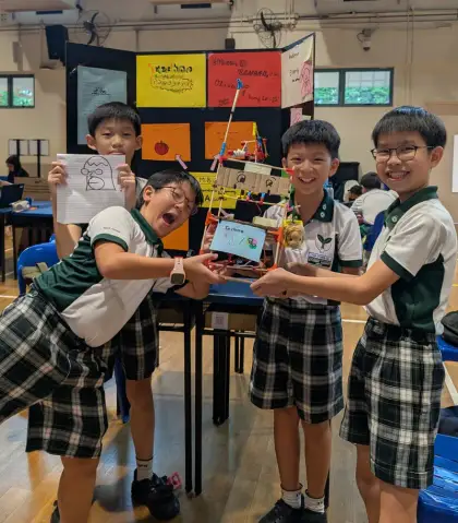 Three boys with their build at Robotics for a Better World 2025