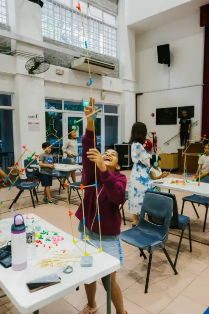 Topping off a tall tower at a school's 50th